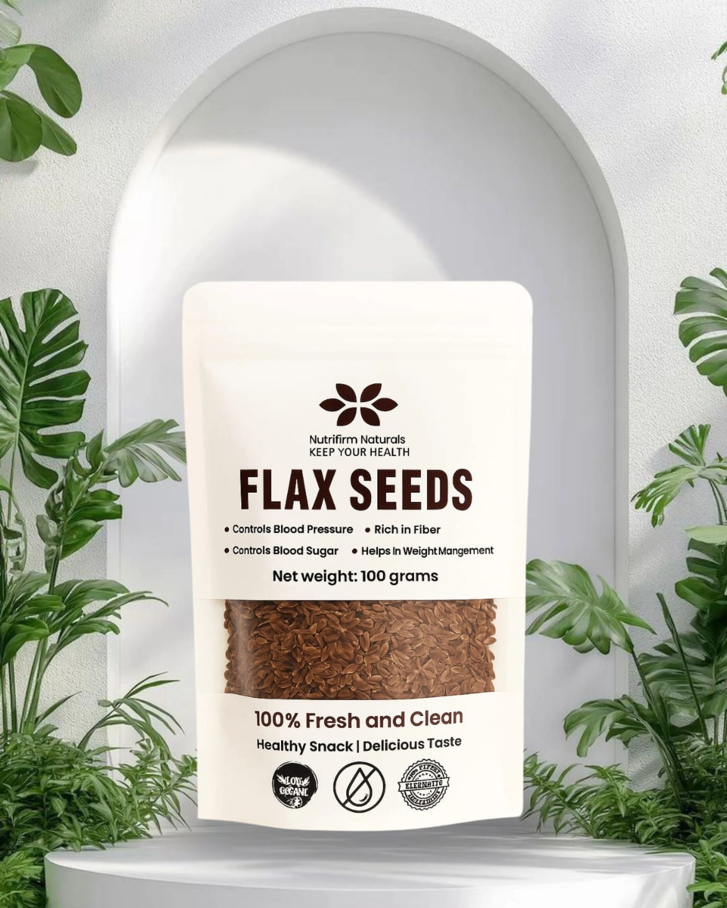 Package of flax seeds with a white background and green plants around
