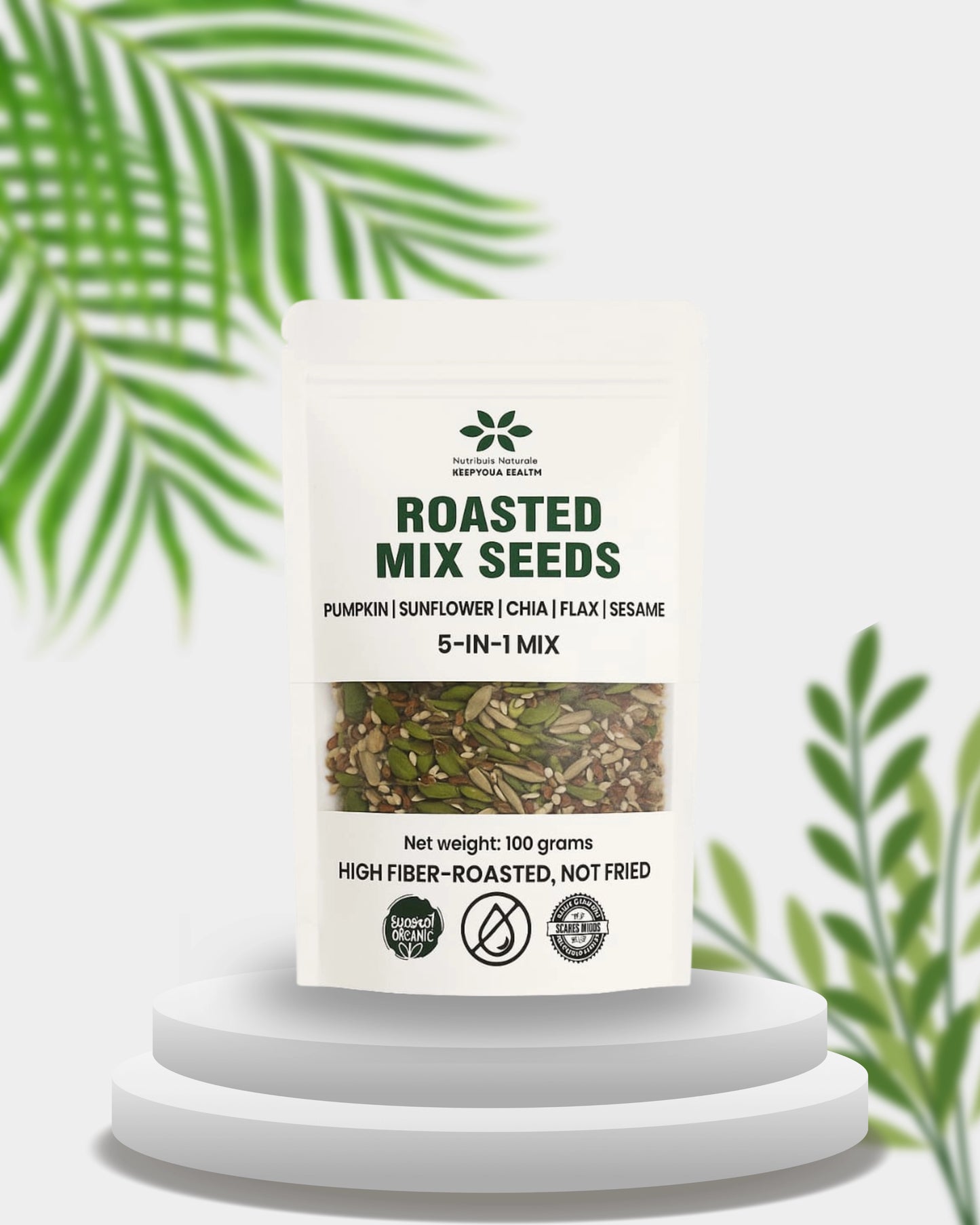 Container of roasted mix seeds with a label on a white background with green leaves.