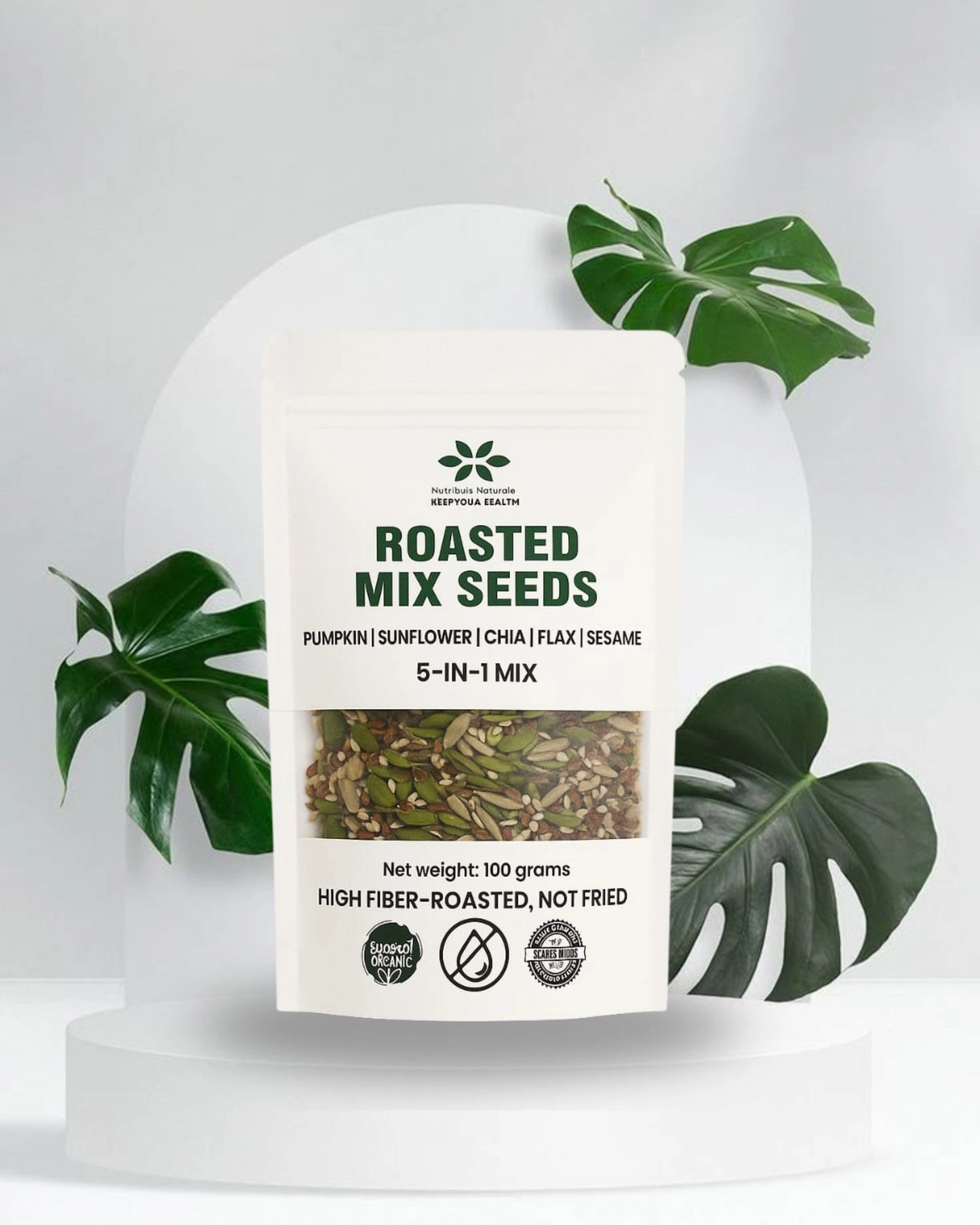 Package of roasted mix seeds with green leaves on a light gray background