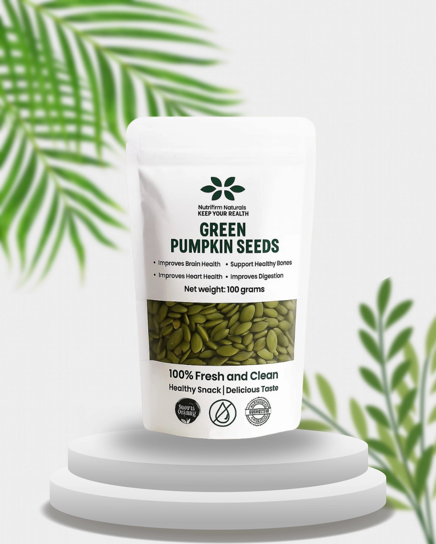 Packaging of green pumpkin seeds with a white background and green leaves.
