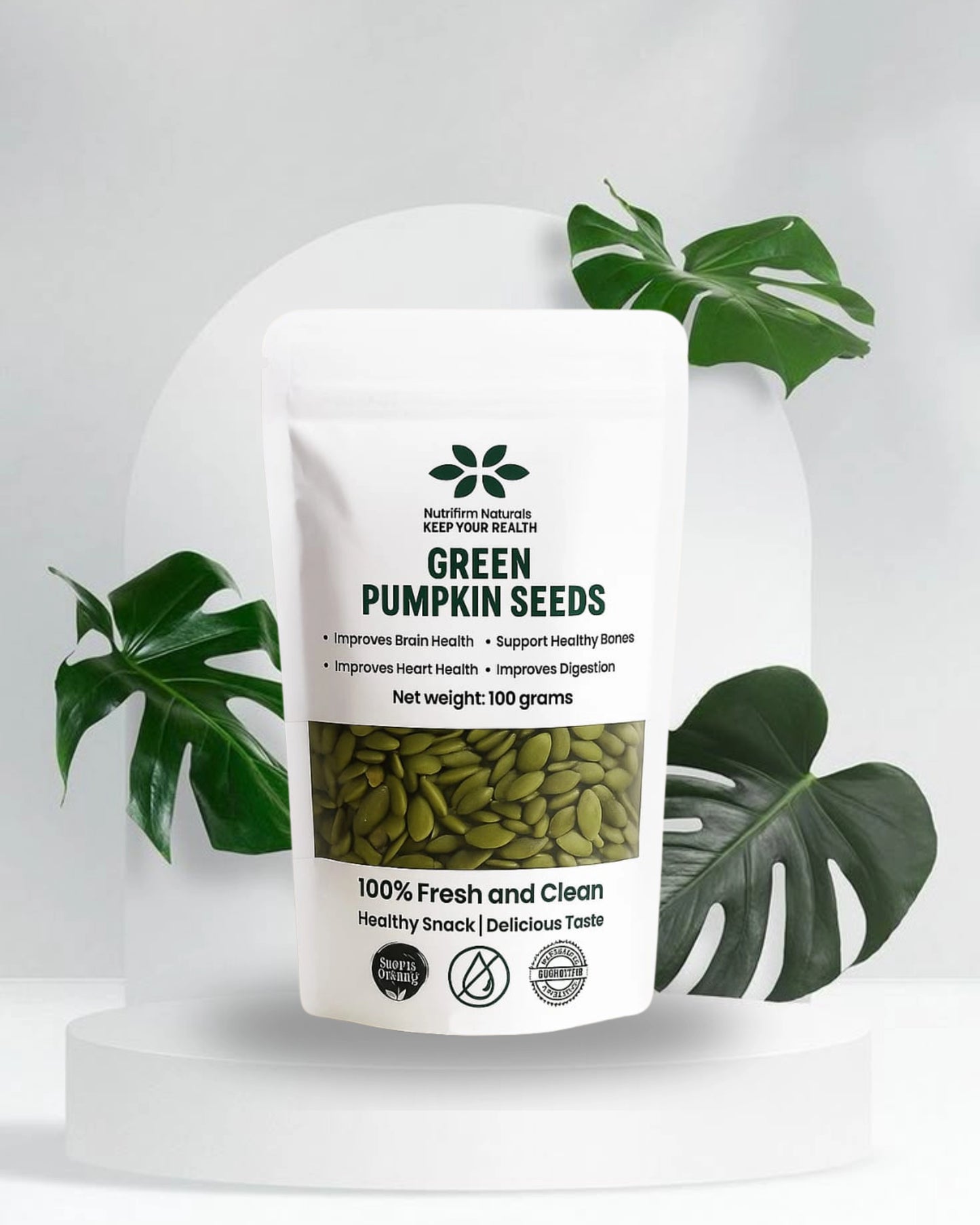 Bag of green pumpkin seeds with a label on a white background with Leaves