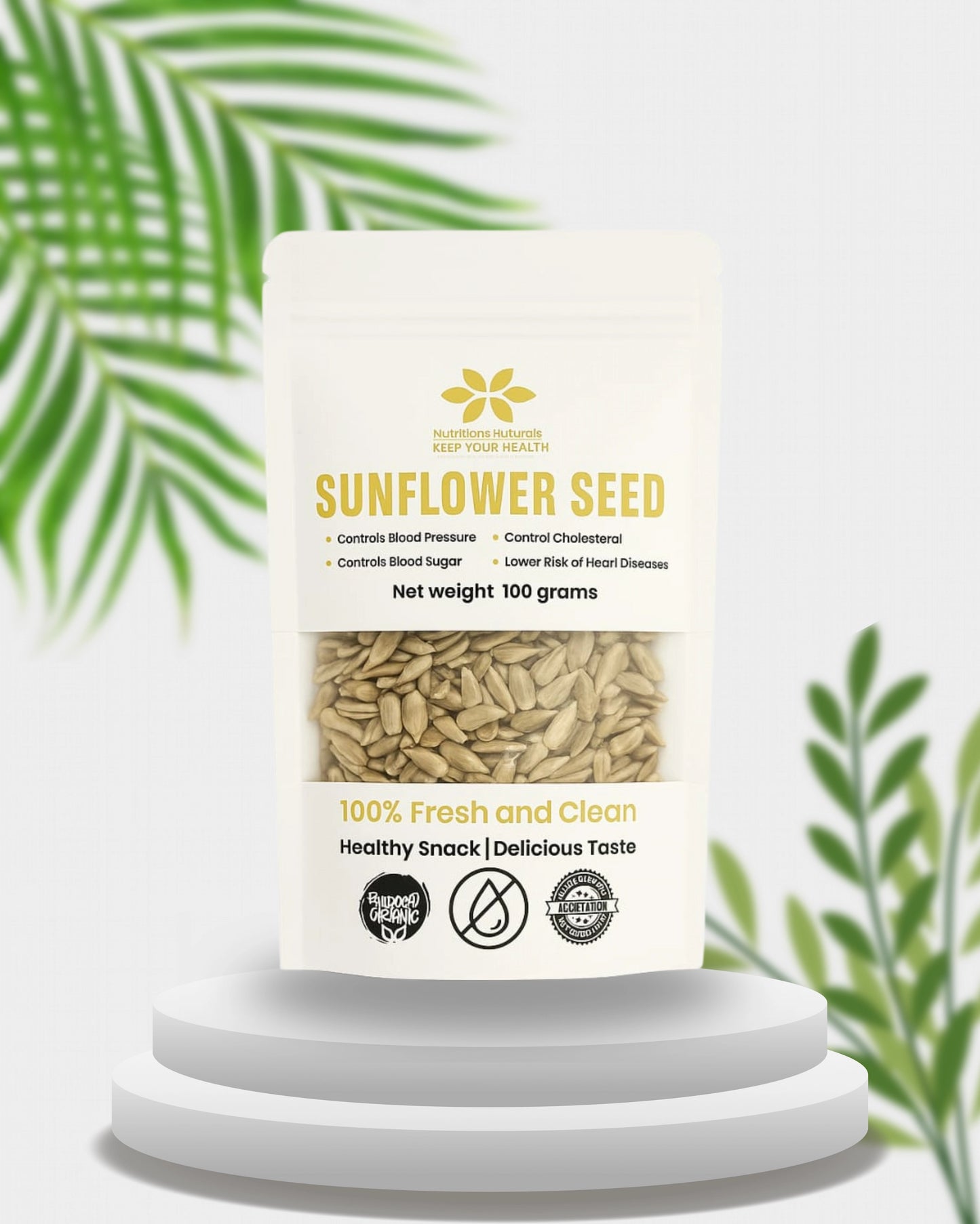 Sunflower seed packaging on a white pedestal with green leaves in the background