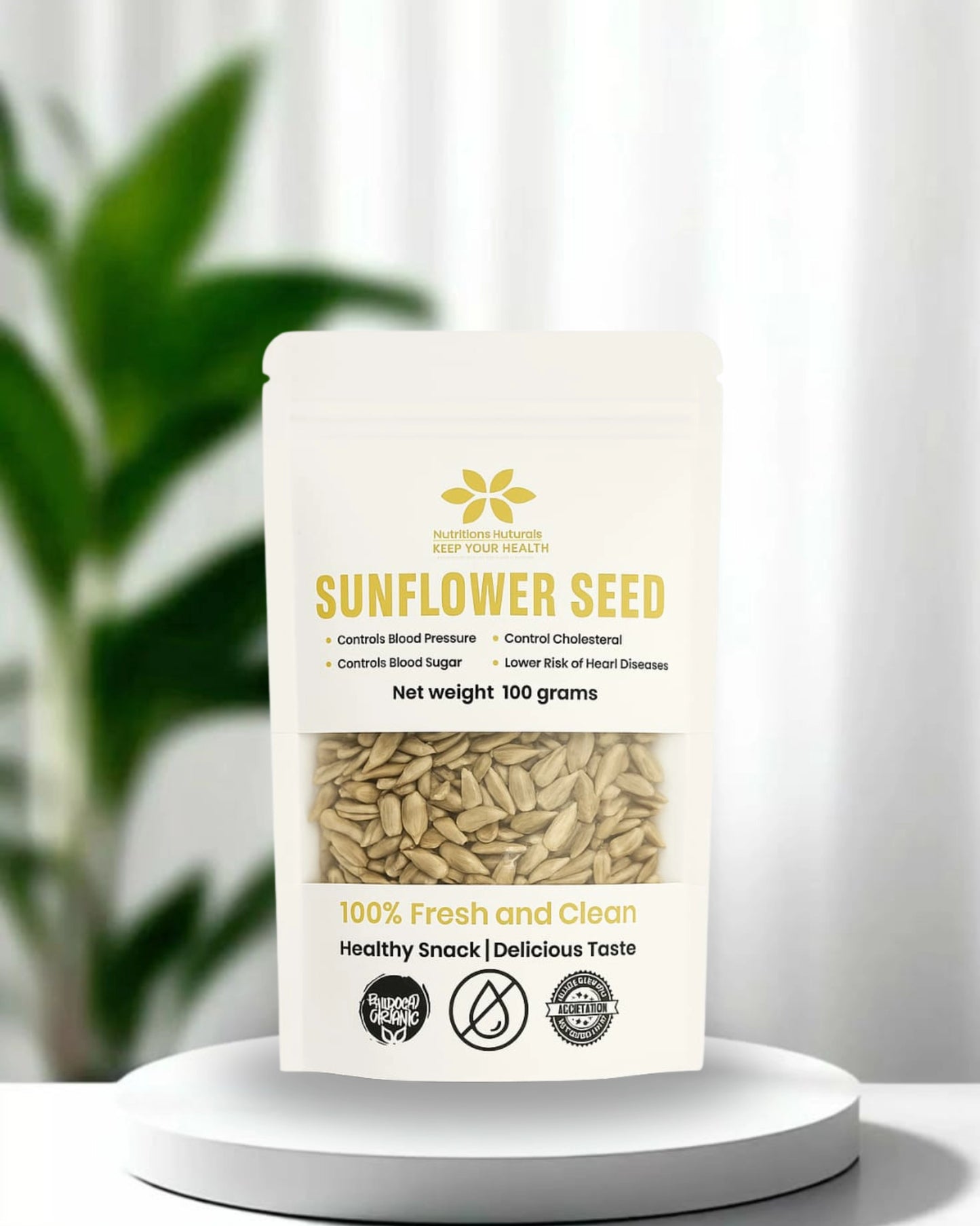 Sunflower seed packaging on a white pedestal with a blurred plant in the background