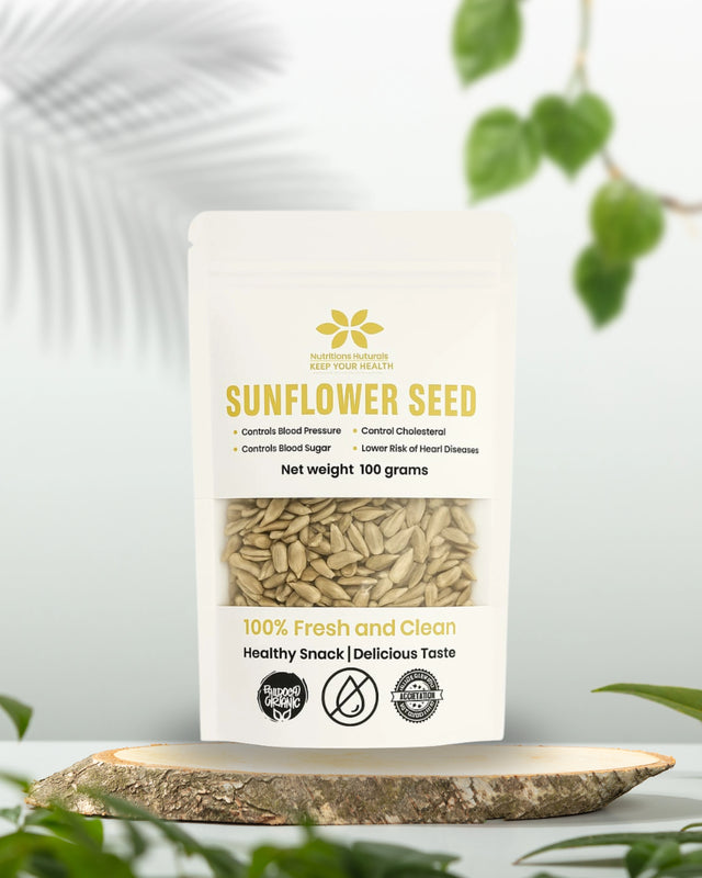 Bag of sunflower seeds with a white background and green leaves.